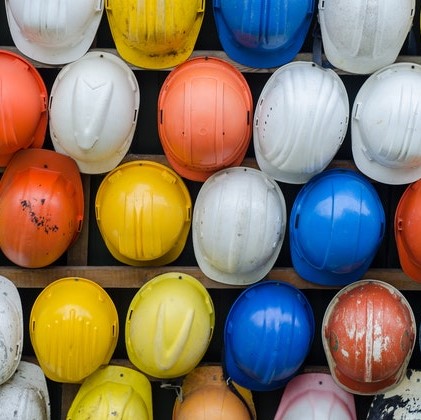 white, blue, and yellow construction hard hats 